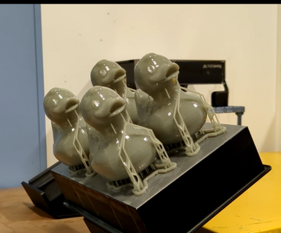 3D printed SLA ducks on build plate after wash